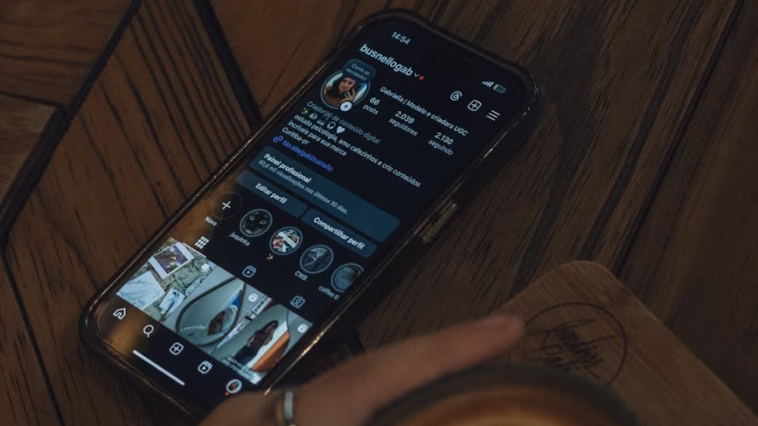 A cozy cafe scene featuring a latte art coffee and a stylish smartphone showing a social media profile.